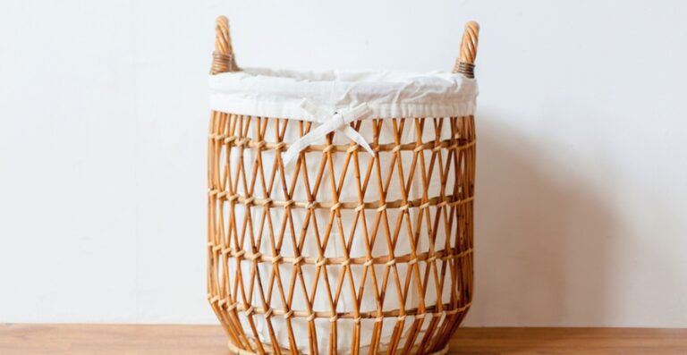 Woven reset basket on living room coffee table containing household items