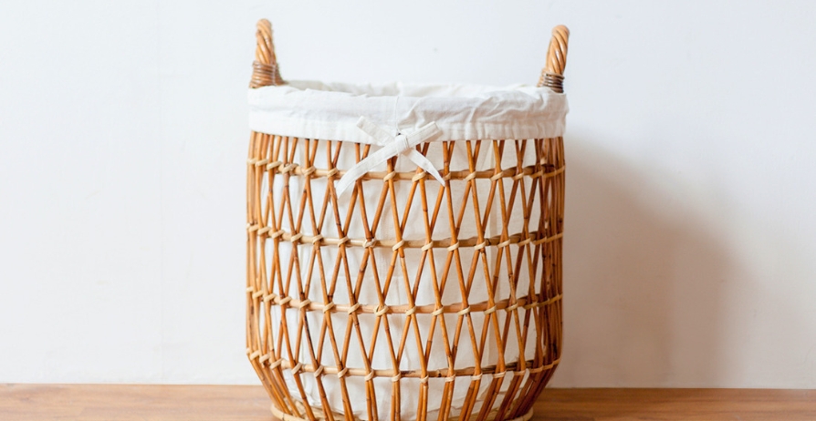 Woven reset basket on living room coffee table containing household items